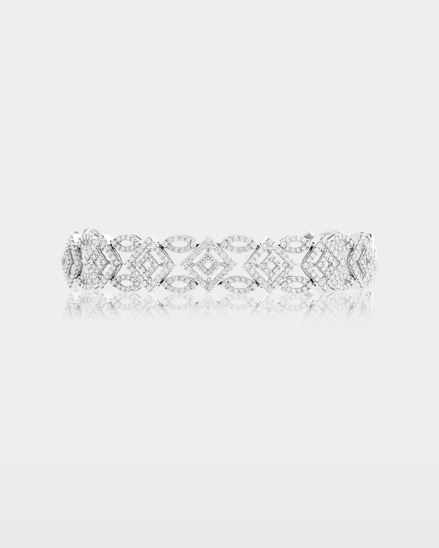 An openwork geometric wide cocktail bracelet in 14k white gold intricately encrusted with brilliant micro pave diamonds