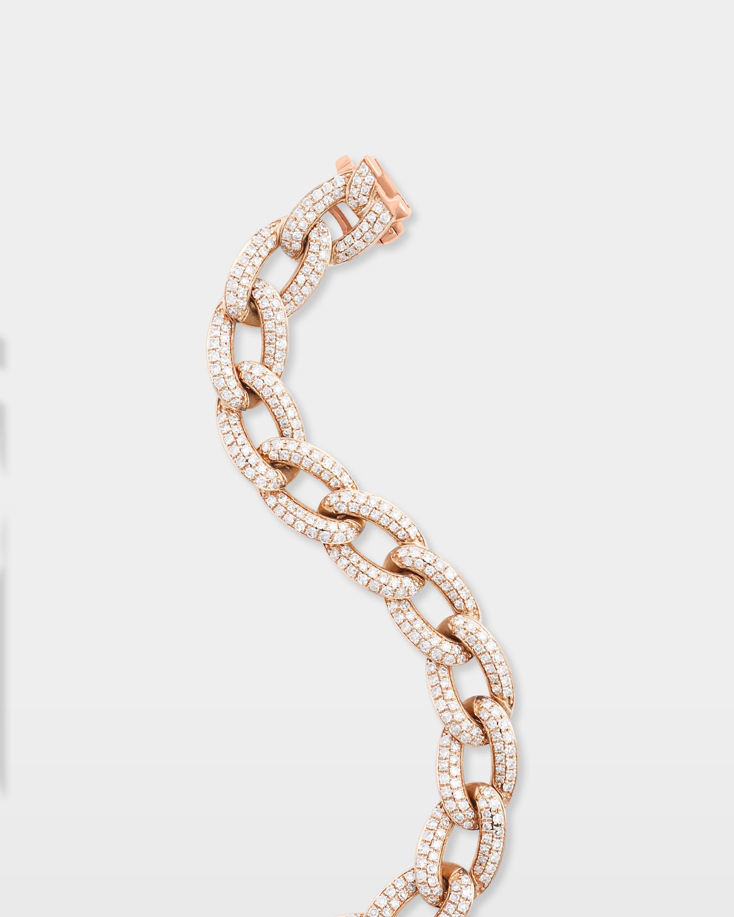 Close-up studio view of a pavé diamond Cuban link bracelet highlighting the integrated custom box clasp and secure safety lock
