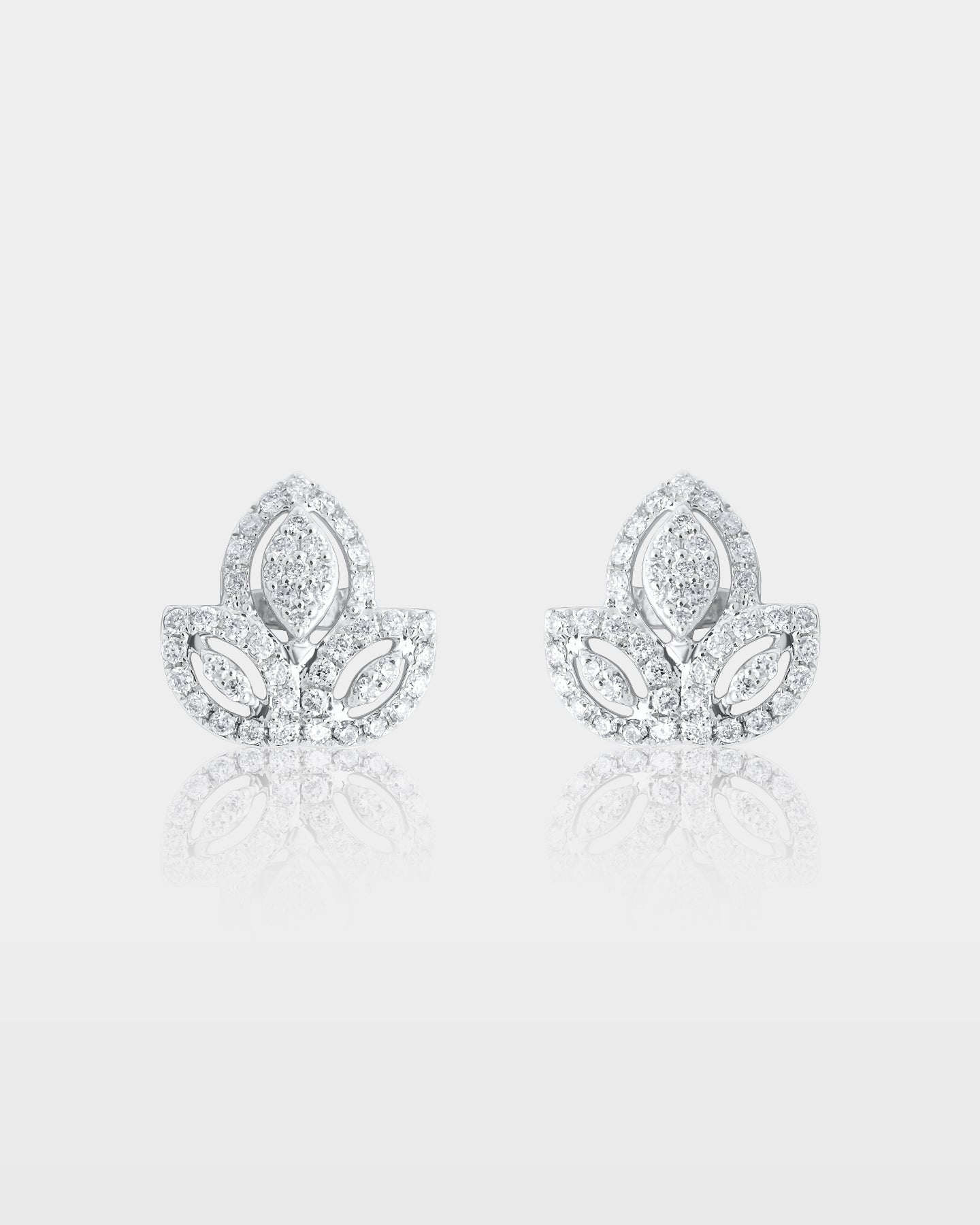 pair of 18k white gold lotus flower stud earrings featuring an openwork multi-petal design encrusted with micro pave diamonds