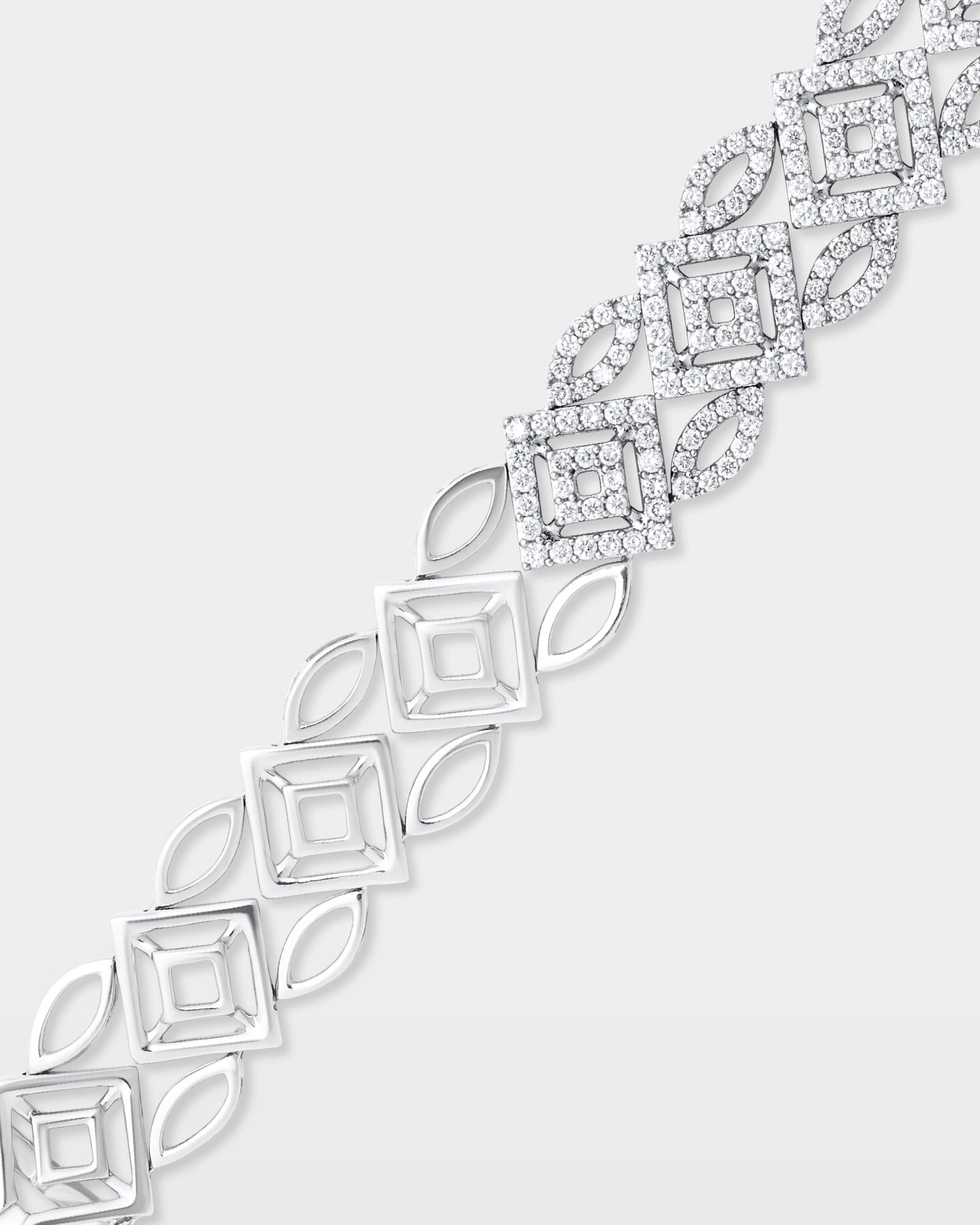 Close-up studio shot showcasing the fluid articulation, open marquise links, and pave diamond details of a 14k white gold geometric bracelet