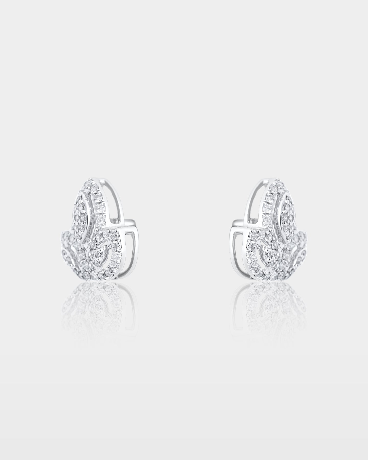 Side and reverse studio view of white gold lotus pave diamond stud earrings showing the metal posts and secure friction backings