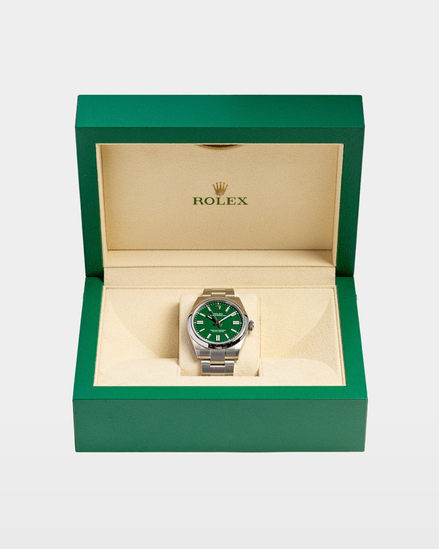 open classic green wave-motif Rolex presentation box displaying a 41mm lacquer green dial Oyster Perpetual watch inside