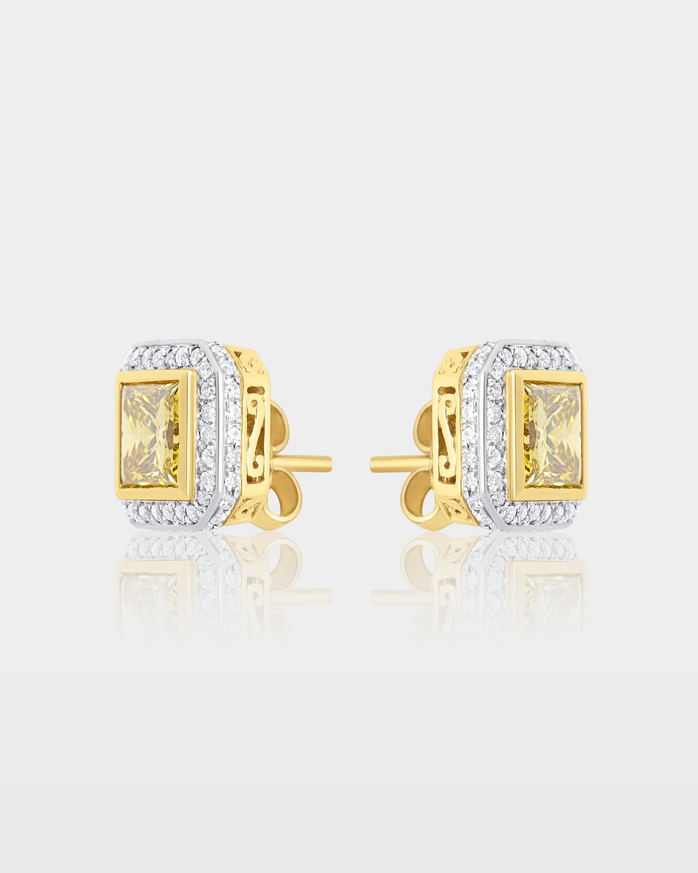 Side and reverse studio view of canary yellow diamond halo stud earrings showing the yellow gold posts and filigree basket gallery
